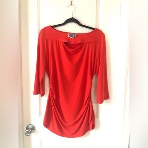 Premise Large women’s top with gold embellishment on neckline.